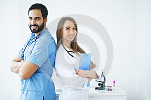 Health Care. Attractive doctors with medical stethoscope work to
