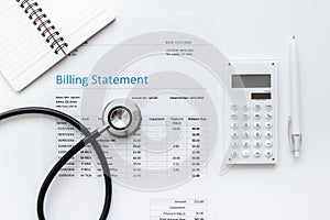 Health care billing statement with doctor`s stethoscope on white background top view mock-up