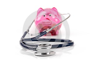 Health care budget and savings piggy bank with stethoscope