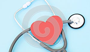 Health care check-up with red heart and Stethoscope on a blue background. Healing care concept and copy space. Above view of