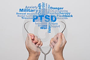 Health Care Concept. Doctor hands holding a stethoscope and PTSD - post traumatic stress disorder words on gray background. War v photo