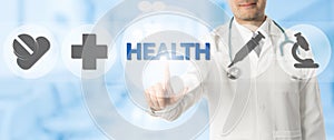 Doctor Points at HEALTH with Medical Icons photo