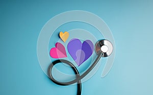 Health Care Concept. International World Heart Day. Paper Cut as Heart Shape with Stethoscope lay on Blue background