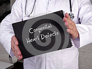 Health care concept meaning Congenital Heart Defects with inscription on the piece of paper