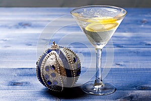 Health care concept. What to drink on christmas party. Glass with water slice lemon on blue table. Reduce alcohol