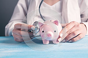 Health care cost. Doctor  piggy bank and stethoscope