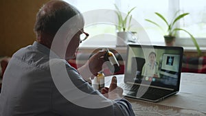 Health care, elderly man with poor health speaks to doctor via video calling using modern technology