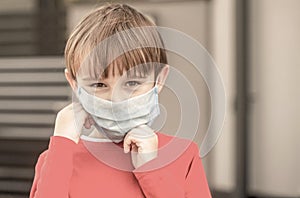 Health care. Face mask for protection coronavirus outbreak. Child wearing a medicine mask outdoors