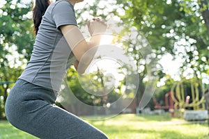 health care female exert on the park. Asian woman doing exercises in morning. balance, recreation, relaxation, calm, good health, photo