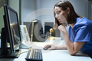 Health Care Female Worker In Hospital With Computer And MRI