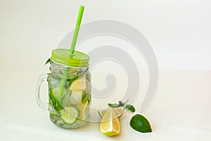 Health care, fitness, healthy nutrition diet concept. Fresh cool lemon cucumber mint infused water, cocktail, detox