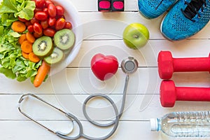 Health Care. Fresh vegetable salad and green apple with medical stethoscope