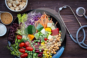 Health Care. Fresh vegetable salad with medical stethoscope for diet and weight loss for healthy care and protect virus,