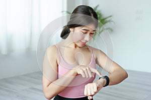 Health care, heart rate monitor, portrait of Asian beautiful woman using smart watch to select health programs such as