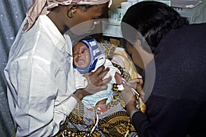 Health care for Kenyan baby with loving mother