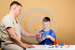 Health care. Medical examination. Boy cute child and his father doctor. Hospital worker. First aid. Medical help. Trauma photo