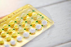 Health care and medicine contraceptive pill prevent pregnancy contraception concept - birth control on wooden background