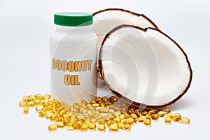 Health care - Nutritional supplement - Bottle of Coconut Oil with halved coconut on the side and scattered gold gel capsule
