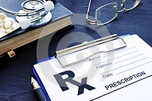 Health care. Prescription form and pills on a desk.