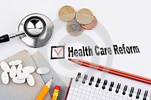 Health care reform. Questionnaire with red cross on the white paper