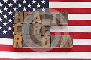 Health care reform in wood type on flag