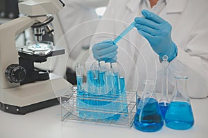 Health care researchers working in life science laboratory. Young female research scientist and senior male supervisor preparing