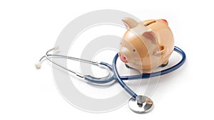 Health care saving concept: a piggy bank wrapped in a stethoscope on white background