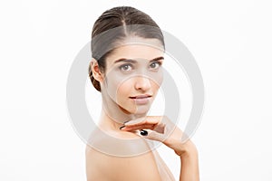 Health care and spa concept - attractive young and healthy woman with nude makeup on white background.