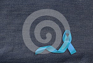 Health care and symbolics concept. Close up of blue prostate cancer awareness ribbon photo
