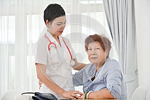 Health care worker helping an elderly patient.