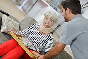 Health care worker helping elderly woman