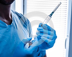 Health care worker holding  injection