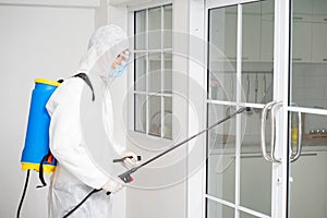 Health care worker in  protective face mask using spraying machine to disinfect virus pandemic.  Health care and