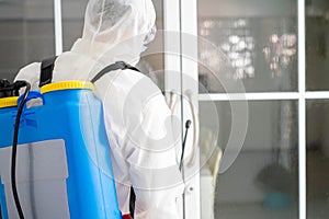 Health care worker in  protective face mask using spraying machine to disinfect virus pandemic.  Health care and