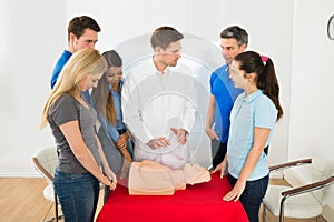 Health class instructor demonstrating cpr techniques