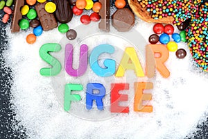 Health concept with multicolored letter blocks on white sugar spelling â€œsugar freeâ€