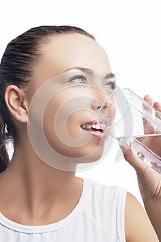 Health Concept: Portrait of Happy Smiling Caucasian Brunette Woman Drinking Clear Water from Glass. Isolated On White