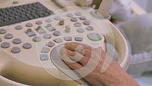 Health diagnostics. Work on an ultrasound diagnostic device, ultrasound examination. Close-up of hands of doctor working