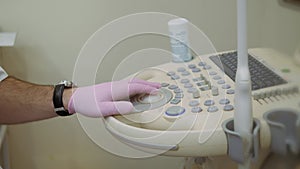 Health diagnostics. Work on an ultrasound diagnostic device, ultrasound examination. Close-up of hands of doctor working