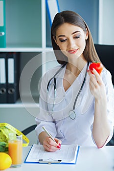 Health. Diet and Healthy. Doctor Dietitian Holding Fresh Tomatoes In Her Hands And Smiles. Beautiful and Young Doctor. High