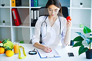 Health. Diet and Healthy. Doctor Dietitian Holding Fresh Tomatoes In Her Hands And Smiles. Beautiful and Young Doctor. High