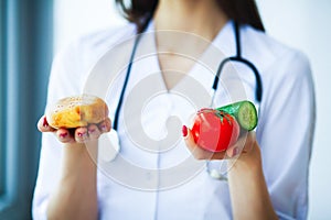 Health. Diet and Healthy. Doctor Dietitian Holding Fresh Tomatoes In Her Hands And Smiles. Beautiful and Young Doctor. High