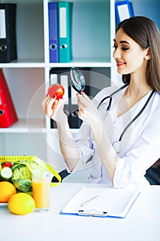 Health. Diet and Healthy. Doctor Dietitian Holding Fresh Tomatoes In Her Hands And Smiles. Beautiful and Young Doctor. High