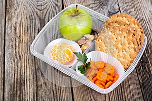 Health and Fitness food in lunch box on wooden background