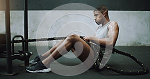Health, fitness and man with weight sled at gym for training, power and intense cardio on wall background. Performance