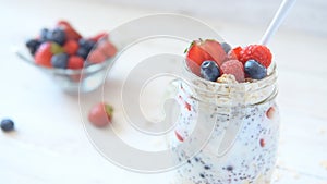 Health food concept - chia seed pudding or smoothie with berries.