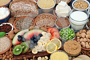 Health food for vegans with almond butter, yoghurt & milk, tofu bean curd, grains, seeds, nuts, fruit, vegetables, cereals, sos