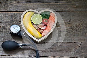 Health heart diet food concept with blood pressure gauge