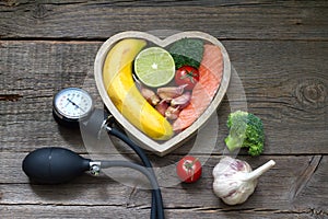 Health heart diet food concept with blood pressure gauge