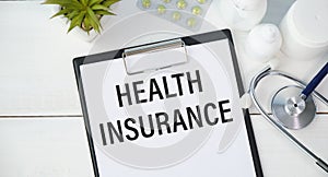 Health insurance claim form with glasses and ballpoint